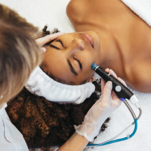 The procedure of aesthetic medicine - woman receiving facial treatments