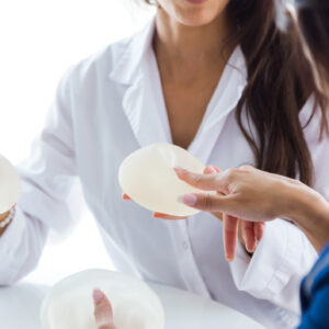 Doctor and her patient discussing silicone and saline breast implants